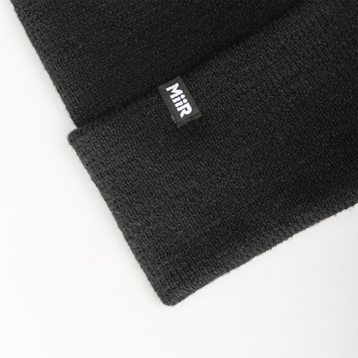 recycled-poly-fine-knit-beanie-d6 WebPDP-RecycledPolyFineKnitBeanie_Studio_TagDetail_Black__BNE005002OS.jpg